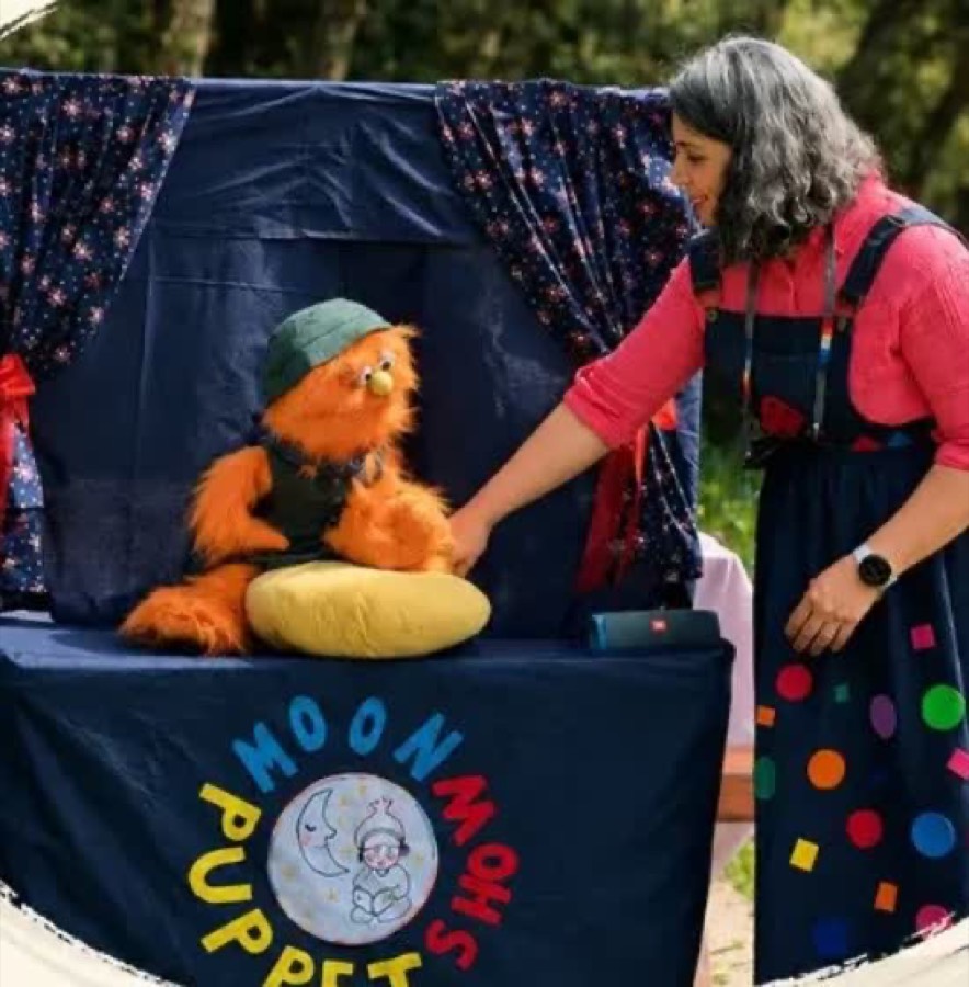 Ms. Teller with Zip on stage, outdoor puppet show performance